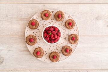 Chocolate lava cakes with fresh raspberries, mint and chocolate pieces on the plate
