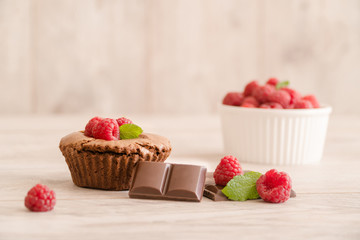 Delicious chocolate lava cake with fresh raspberries, mint and bowl of raspberries