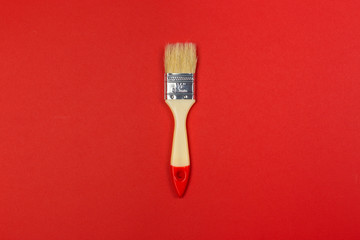 Painting brush on bright colored background top view