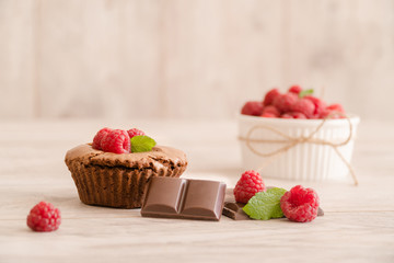 Delicious chocolate lava cake with fresh raspberries, mint and bowl of raspberries