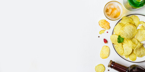 Beer and potato chips on a white background