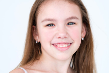 emotion face. happy delighted smiling child. closeup little girl portrait on white background. mood...