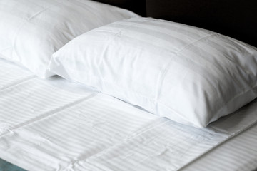 Fototapeta na wymiar white pillows on bed in modern bedroom at home