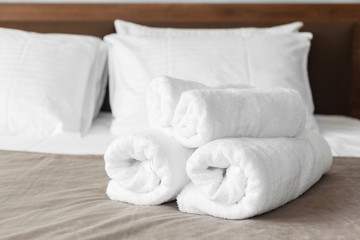 White towel on bed in guest room for hotel customer