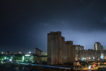 Fototapeta na wymiar lightning over the city at night