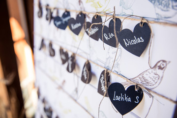 Heart Shaped Wedding Guests Paper Name Tags on Board.