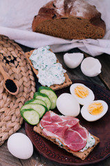 Italian style lunch jamon snack decorated with boiled eggs and cucumbers.