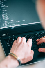 programmer writing code on his laptop. web developer designing application. internet technologies...
