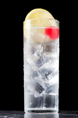 Classic Tom Collins cocktail on black background