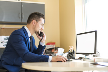 Business man working at a car dealer smiling