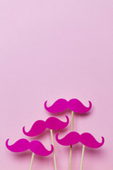 Pink moustache on a pink background. Modern masculinity concept