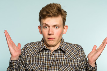 uncomprehending bewildered puzzled perplexed confused man. portrait of a young guy on light background. emotion facial expression. feelings and people reaction. - obrazy, fototapety, plakaty
