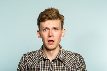 omg unbelievable shock amazement. dumbfounded man with open mouth. portrait of a young guy on light background. emotion facial expression and reaction concept.
