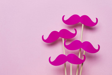 Pink moustache on a pink background. Modern masculinity concept