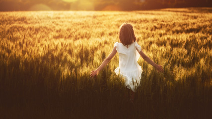 Girl running on cereal field