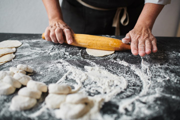 Woman rolling the dough by rolling, slow motion at 240 fps