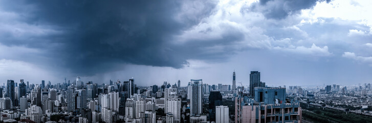 rain clouds over city, panoramic aerial cityscape, residential buildings and business skyscraper