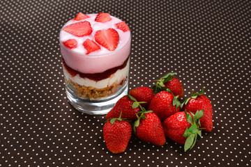 Home made granola breakfast with strawberries and plain yogurt, served in the glass.