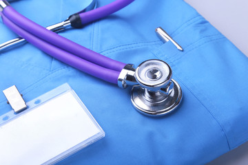 Medical stethoscope lying on a blue doctor's form and notepad close-up. the therapist's work space.