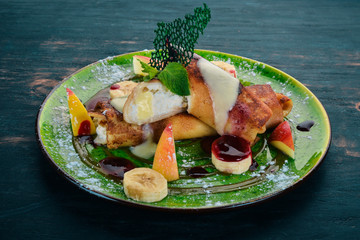 Pancakes with cottage cheese, fruit and jam. dessert. On a wooden table. Top view. Copy space.