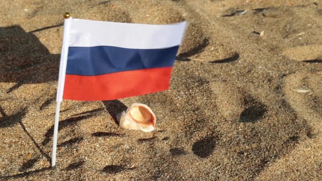 Flag of Russia on a sandy beach.