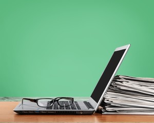 Laptop and black glasses on desk