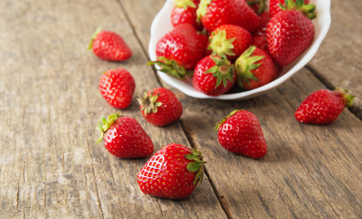 Ripe red strawberries on wooden table