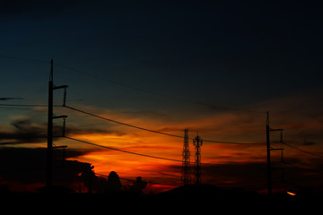 silhouette of power electric line pillar and colorful sunset