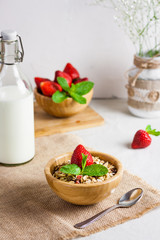 Homemade granola with fresh milk and strawberries for healthy breakfast