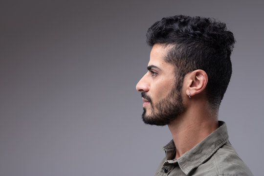 Studio profile portrait of young bearded man