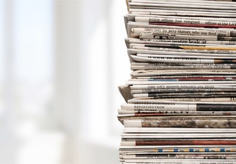 Pile of newspapers on white background