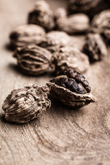 Whole black cardamom on wooden background