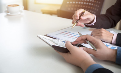 Two businessmen analyst discussion in office and looking at report for checking in financial statement for audit internal control system. Accounting or accountancy Concept.