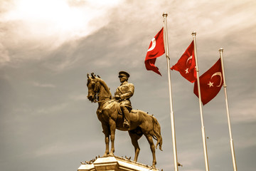 The statue of Ataturk and national flags of modern Turkey in Ulus - Ankara, Turkey
