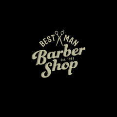 Obraz premium Barbershop logo. Scissors and letters like an emblem on a dark background. Monochrome option.