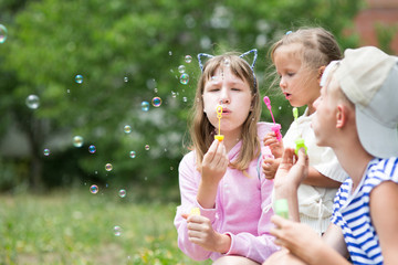 children blowing soap bubbles