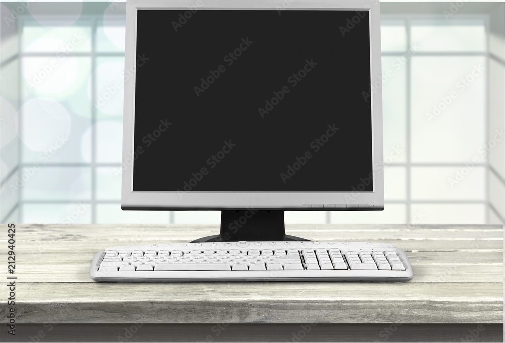 Poster desktop computer and keyboard on desk