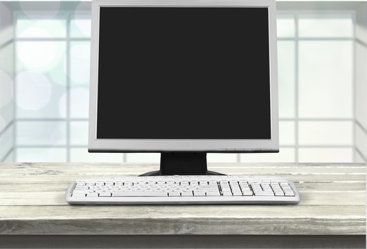 Desktop computer and keyboard on desk