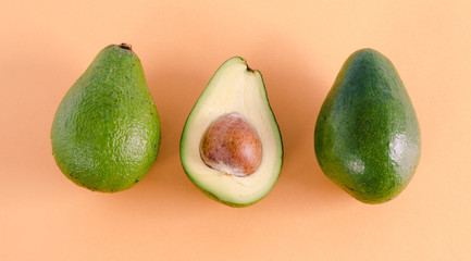 Avocados on color background. Flat lay.