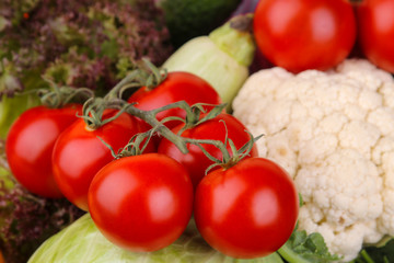 Different vegetables including tomatoes, zucchini, cauliflower and lettuce close-up. Background