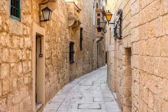 Fototapeta beautiful view of ancient narrow medieval street town Mdina, Malta