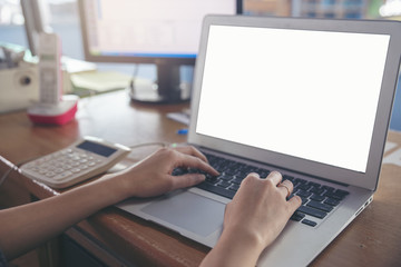 Business and finance concept.Financial adviser planning and working on laptop,Business woman typing at office.Calaulator,computer and phone on wooden table.