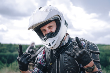 Adventure motorcyclist gear, A motorbike driver looks, close up portait, rider man in helmet, concept of active lifestyle, enduro travel road trip