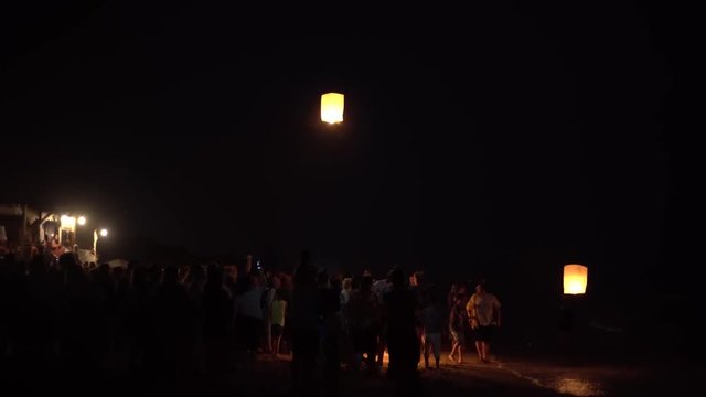 Sky lanterns flying in the beach at night
