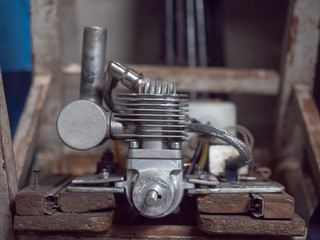 An old mechanic device mounted on workbench in vehicle sprung. Close up view on worktop with vintage iron device splined. An old home workshop. Blurred background, soft selective focus