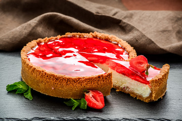 Cold cheesecake with strawberry and strawberry jelly.