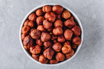 Raw hazelnuts in bowl. Top view