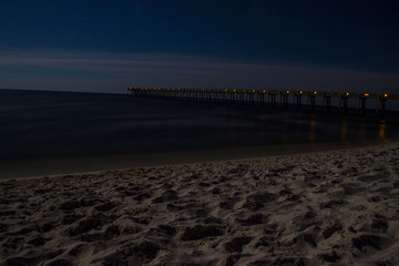 Fototapeta na wymiar Pier on ocean at night
