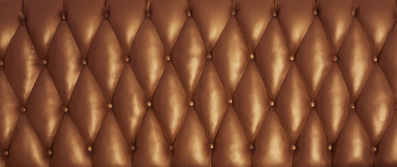  The bronze surface of the leather back of the vintage couch. 