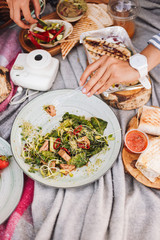 Close up amazing picnic with variety of tasty food on picnic blanket in city park